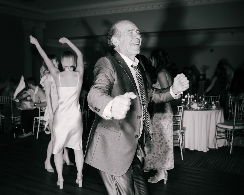 Wedding guest dancing joyfully at the reception