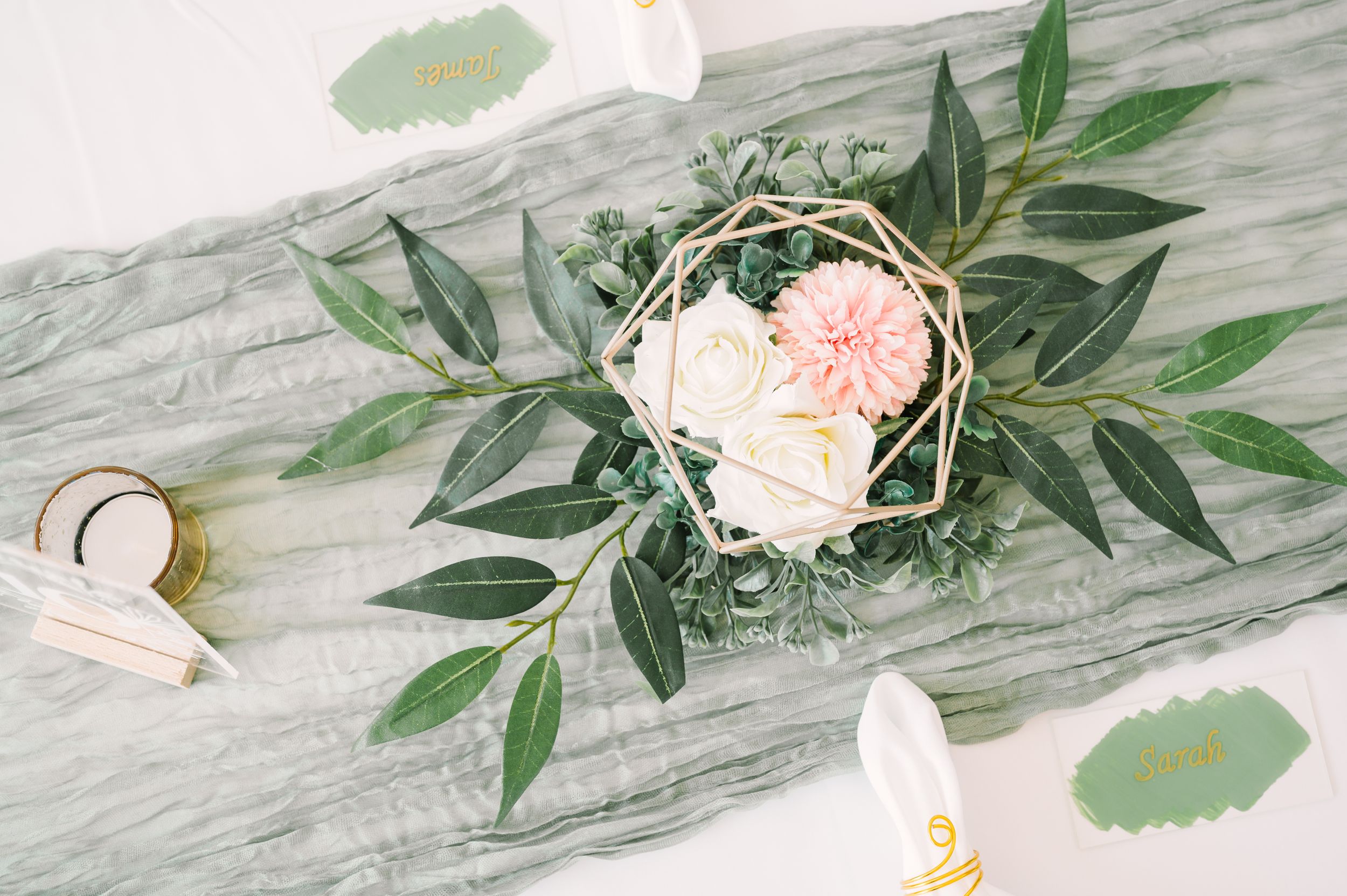 Soft green wedding tablescape with florals