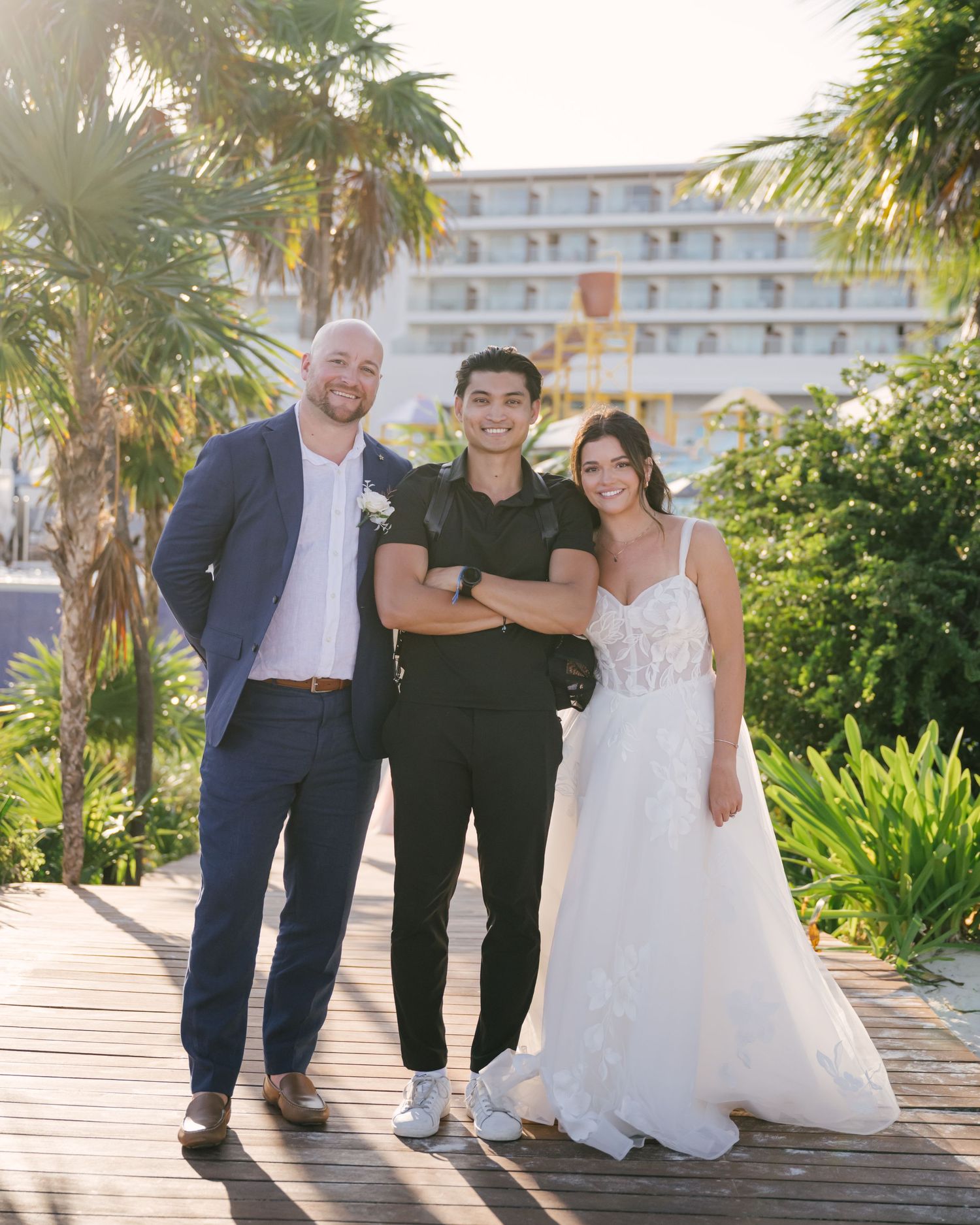 Phil standing between newlyweds after their destination wedding